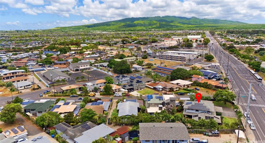 Aerial view showcasing the expansive corner lot property and surrounding neighborhood layout.