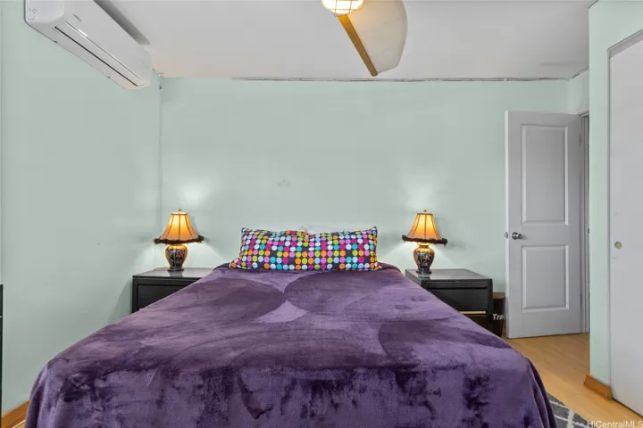 Additional Bedroom with Split AC and ceiling fan. Corner room with two windows.