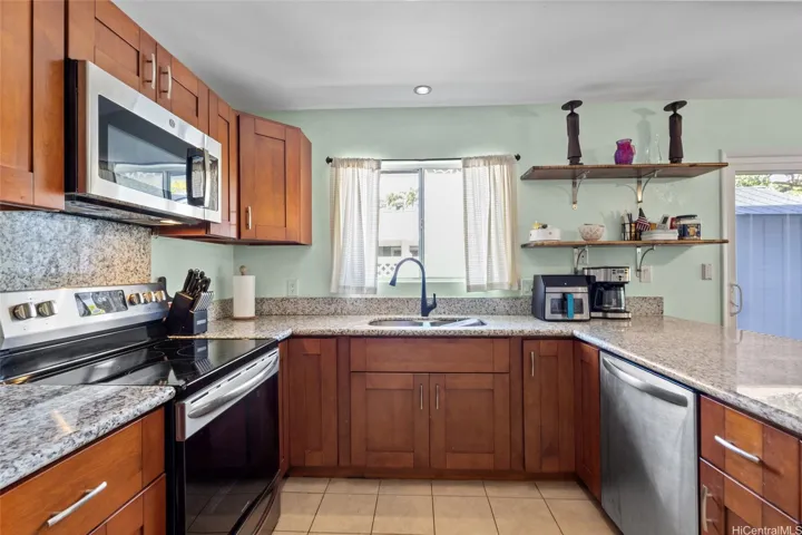 Lovely Kitchen. Sink faces window. Bright paint. Dishwasher and plenty of storage! Featuring the Microwave hood to vent, matching appliances with everything you need from large counter space to a nice sliding glass door entry. Plenty of shelves, closets and cabinets to store all of your favorite ingredients. Yum!