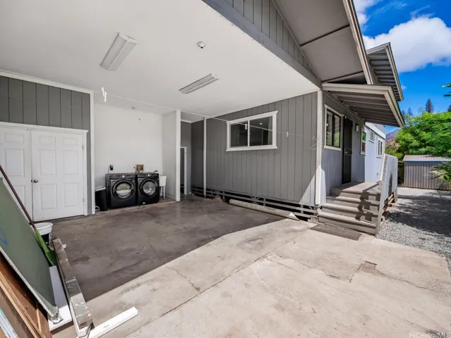 Extra large bonus storage space in the back of the carport with washer and dryer. Potential for a great work out or workshop space.
