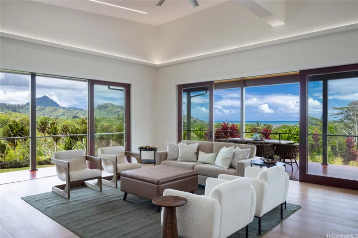 Experience Hawaii's signature indoor-outdoor lifestyle as mahogany-framed sliding glass doors disappear, seamlessly connecting the great room to expansive lanais with panoramic Ko'olau Mountain, ocean, and iconic Mokoli'i views.