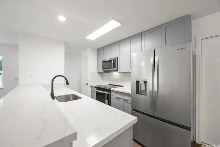 Open kitchen area with counter top seating