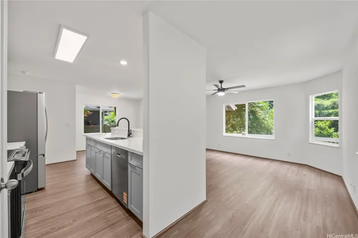 Open kitchen area with counter top seating and ample natural light