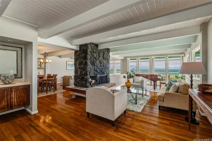 Open floor plan features ohia wood flooring.