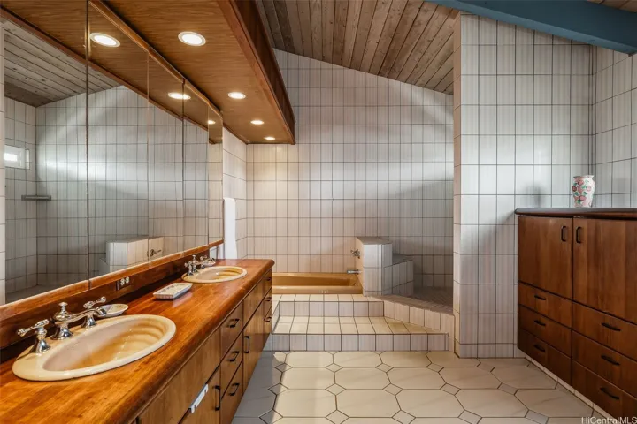 Primary bathroom w/teak custom cabinets/counters.
