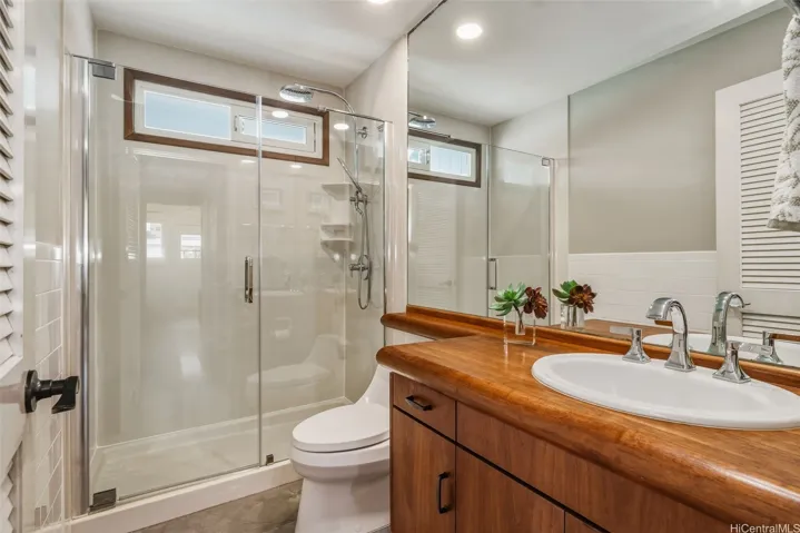 Main level bath w/ custom teak cabinetry/counters.