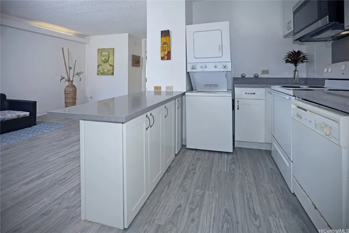 Open kitchen layout with stacked washer and dryer