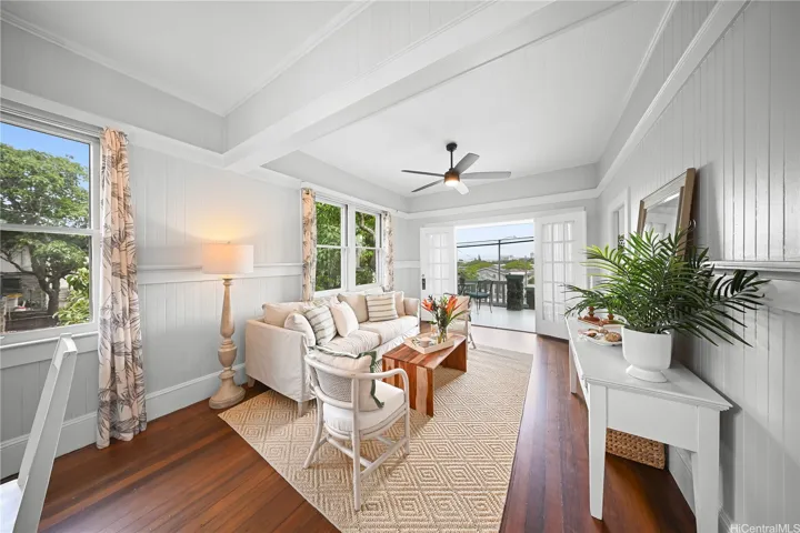 Spacious dining/living room for entertaining, leading out the doors to the covered front porch.
