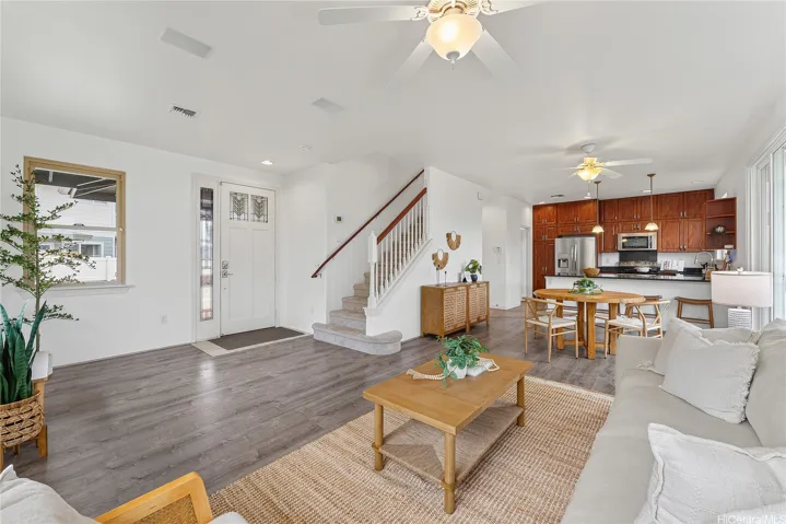 Open living area connecting seamlessly to the dining and kitchen spaces, with easy access to the second floor.