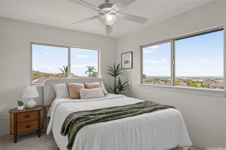 Second bedroom with windows on two sides, bringing in natural light and scenic neighborhood views.