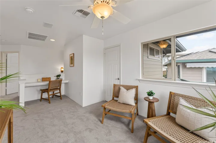 Sitting area from a different angle featuring a built-in desk.