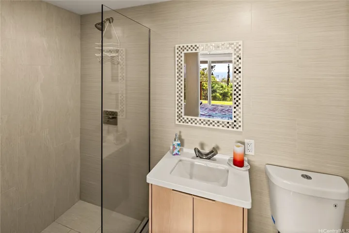 En-suite downstairs bathroom features a sleek walk-in shower.
