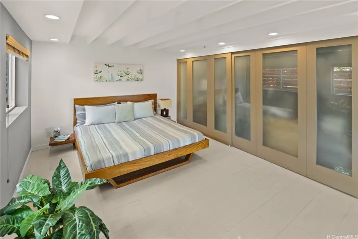 This bedroom features a wall of opaque glass closet doors.