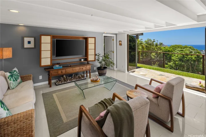 This downstairs entertainment room is situated between the two lower-level bedrooms, and it opens to the vibrant outdoors.