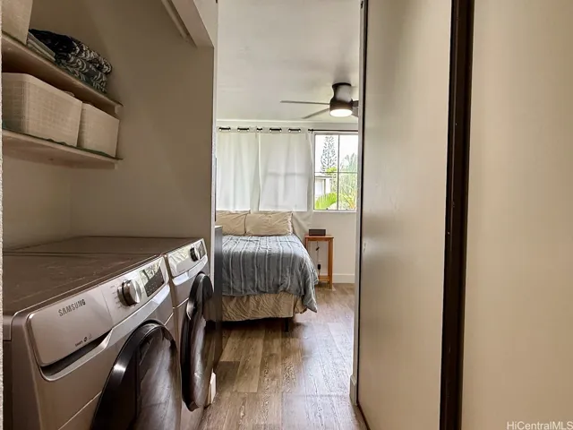 Laundry area and primary bedroom