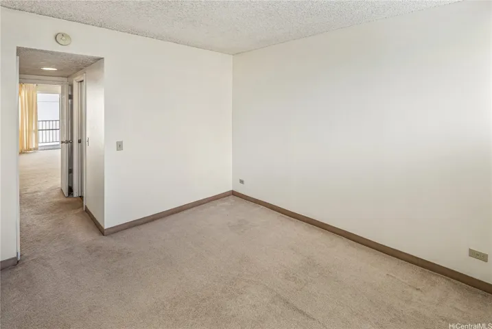 The hallway between the primary bedroom and living room includes a bathroom on the right and closet on the left.