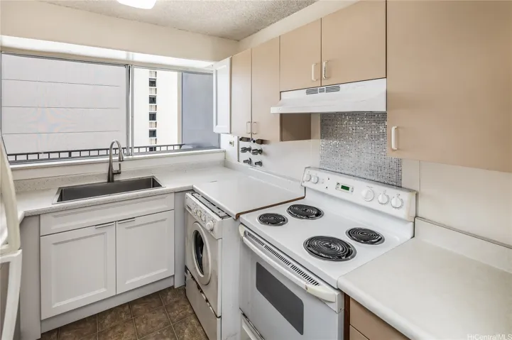 The washing machine is in the original kitchen.