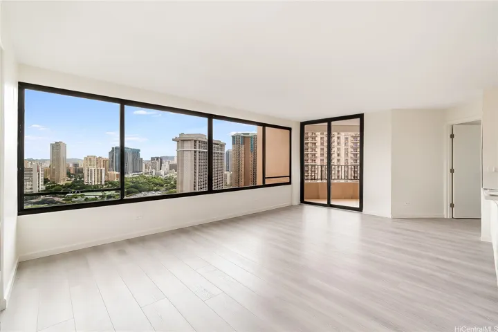 Bright, open living space flooded with natural light and sweeping Waikiki views