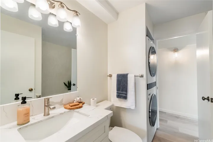 Primary bath contains stackable washer and dryer.