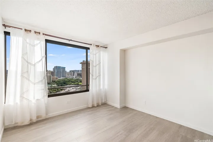 Second bedroom or flex space — large windows with city views