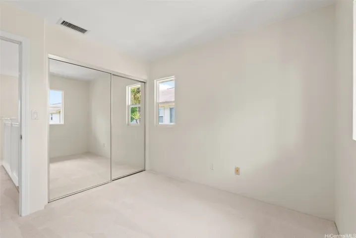Bedroom #2 of 3 with brand new carpet, fresh paint & mirrored closet doors.