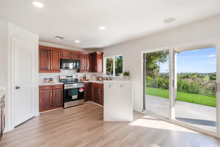 The kitchen window looks out on exactly the kind of afternoon Kapolei's known for.