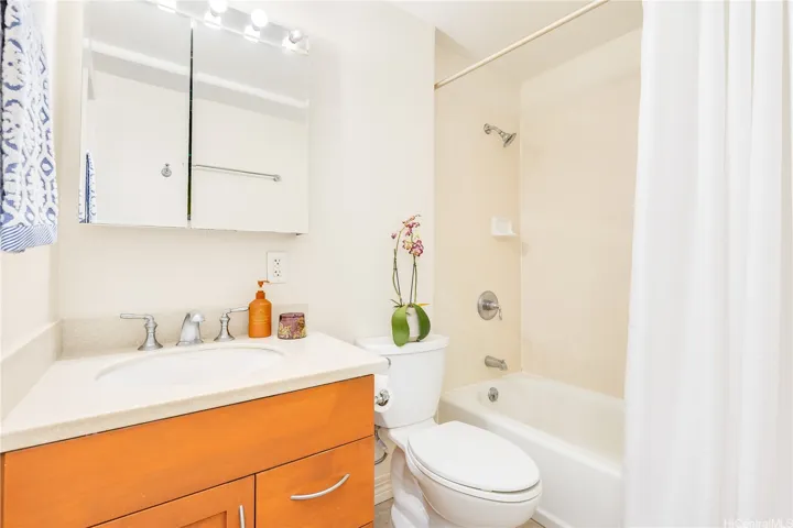 Full Bathroom with tub, shower, and vanity.