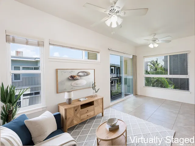 Large windows in the living room and sliders to the lanai - virtually staged