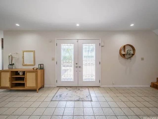 Welcoming double-door entry opens to bright, inviting interiors.