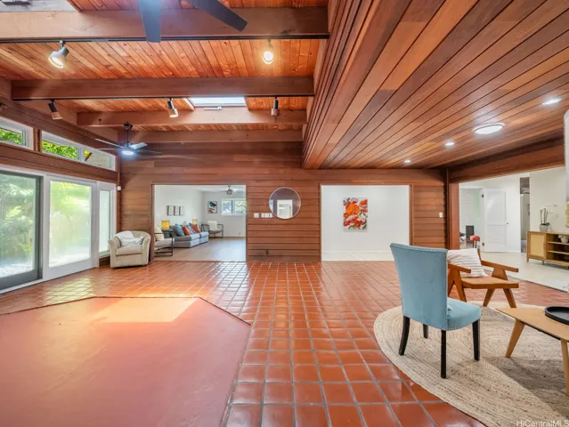 Expansive main living area with warm wood ceilings, abundant natural light, and grand, flexible space for entertaining.