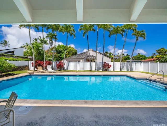 Hale Kai's community clubhouse opens to the pool area, offering a comfortable setting for recreation and gatherings.