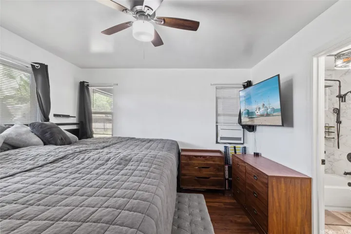 This primary bedroom fits a massive double king sized bed, adjacent laundry room and en suite full bathroom.