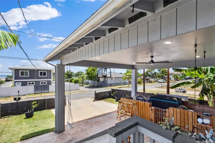 Carport currently has small play area for a young child. This structure can and will be removed or left at buyer's preference. The grass in enclosed by functional custom fencing. Room to grow plants, stretch out, relax and even check the mail! Large driveway perfect for parking and parties. Four car parking with powerful ceiling fan, recessed lighting and shade coverage. No maintenance or association fee!