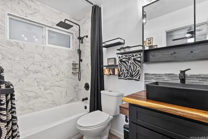 Second updated bathroom is great for guests, fully appointed with recessed storage in the wall.