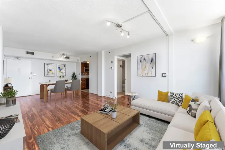 Beautiful laminate flooring highlights the well-lit living room.