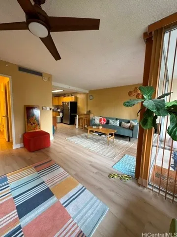 Enhanced.  Second bedroom area used as family room looking to living room and kitchen