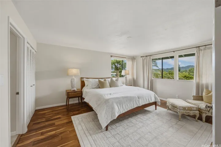 Primary suite with beautiful engineered hardwood flooring, ensuite, cool cross breezes, and tropical views.