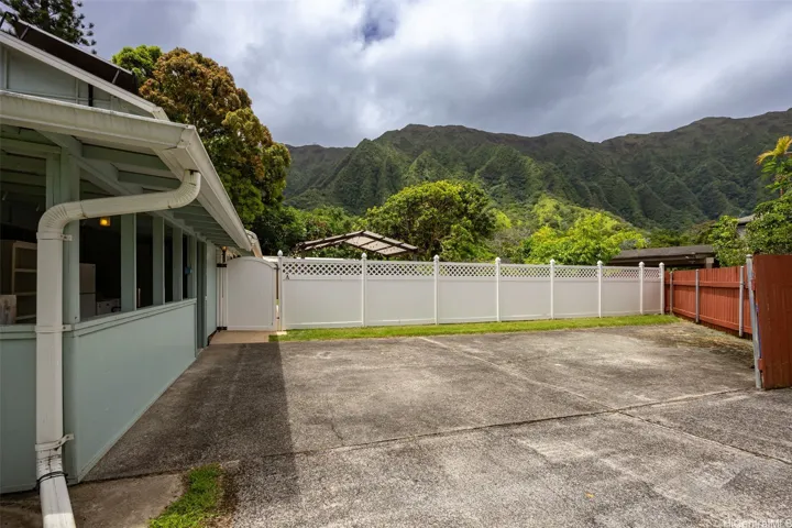 The home's parking pad can accommodate at least 3 vehicles. The outdoor storage space on the left includes
shelving, a second refrigerator, and washer & dryer. There is an additional space inside the home with electric and water supply for additional washer & dryer.