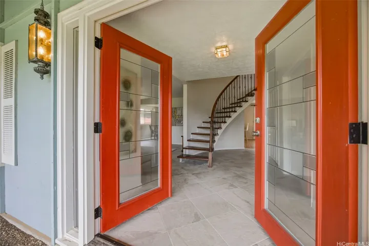 Main entrance where guests are welcomed by the stately staircase.