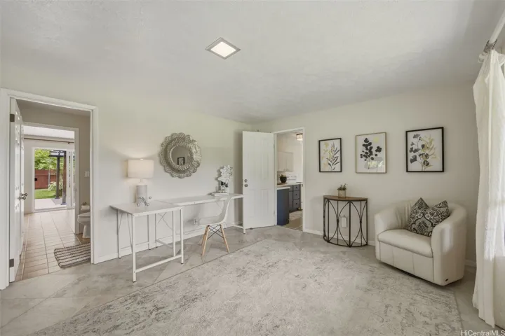Main level den that can also be used as a bedroom. The door on the left leads to the main level full bathroom and the door in the center of the photo leads to the bonus space with wet bar, 2 bedrooms and bathroom. This
door to the bonus space can be locked from both sides to separate the space.