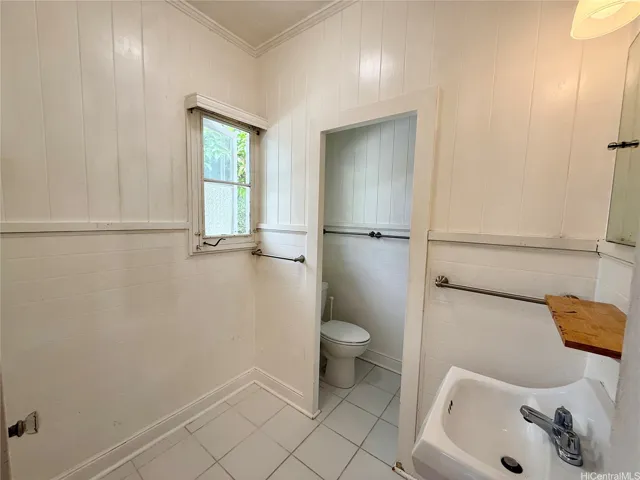 Quaint white bathroom with space to add your personal touch.