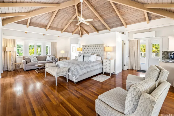 Primary upstairs bedroom features Australian eucalyptus hardwood floors, a reading/sitting area,and built-in bookshelves.