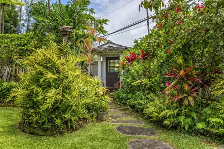 Entry gate for privacy/security opens into a lush tropical setting.
