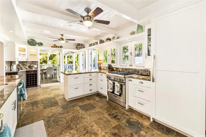 Custom kitchen features French windows, Thermador gas/convection oven, Miele freezer and Miele refrigerator, walk in pantry, wine fridge, wet bar.