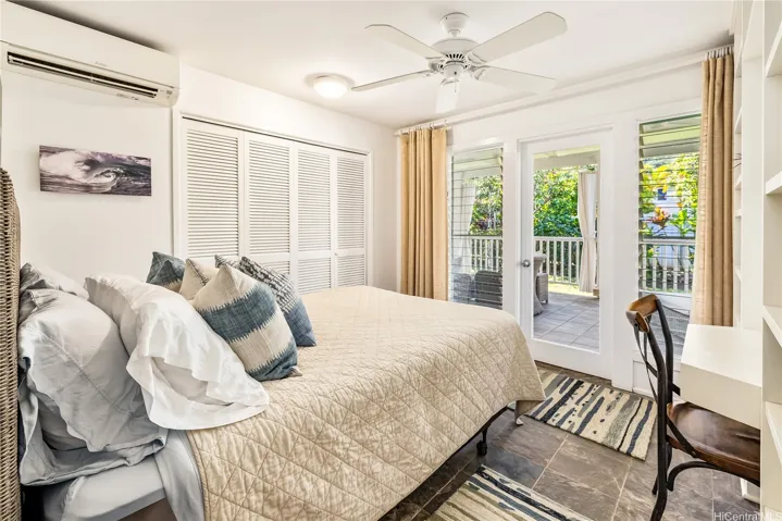 Bedroom 1 on main level opens to front lanai through French doors.