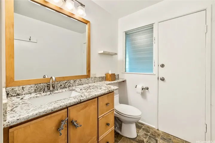 Bath 1 on main level opens to back lanai for convenience.