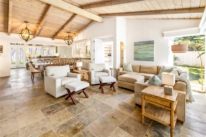 Inviting living room w/impressive wood-vaulted ceilings/slate floors opens to dining/kichen/front lanai.