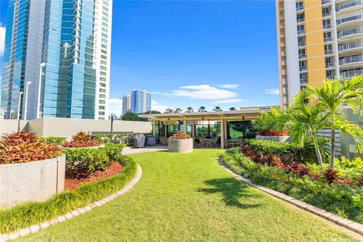 Another view of beautiful manicured landscaping and private BBQ entertainment venue.