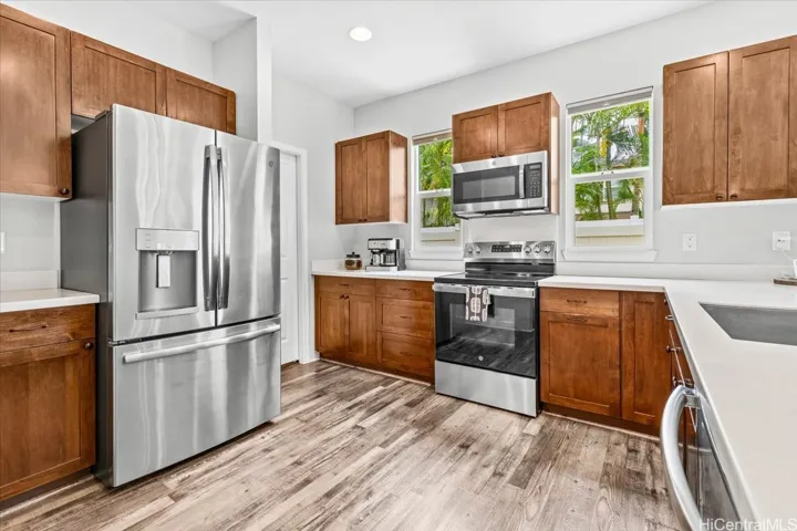 Raised-panel cabinetry, stainless steel appliances