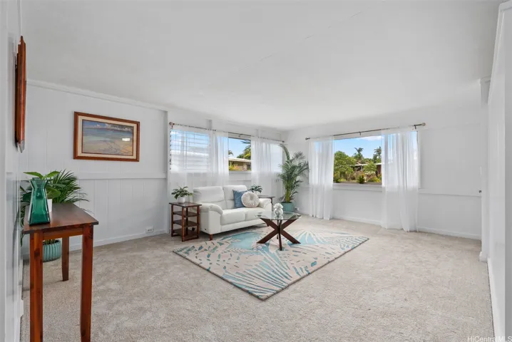 This home greets you with beautiful natural light and many areas to gather, like this living room area. Enhanced